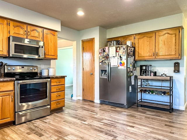917 SE Allyn St, Ankeny, IA 50021 - kitchen featuring brown cabinetry, stainless steel appliances, recessed lighting, light wood-style flooring, and baseboards