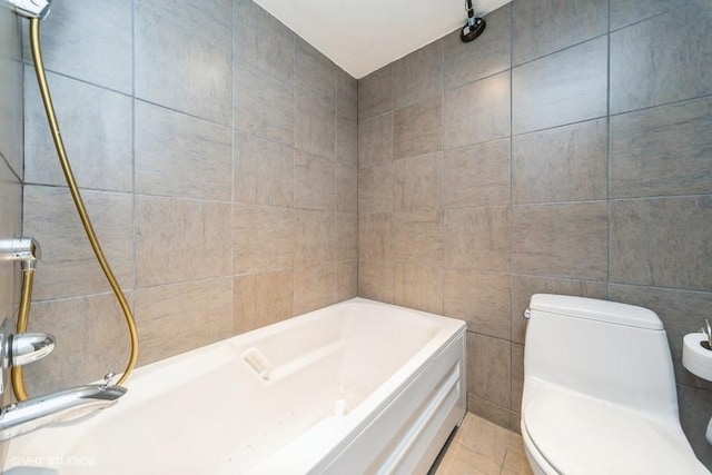 full bath with tile patterned floors, tile walls, toilet, and a bathtub