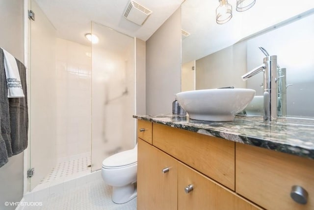 bathroom with toilet, vanity, visible vents, a stall shower, and tile patterned flooring