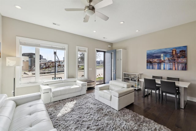 living area featuring recessed lighting, a wealth of natural light, a ceiling fan, and dark wood-style floors