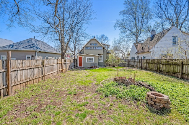 view of yard featuring an outdoor fire pit and a fenced backyard