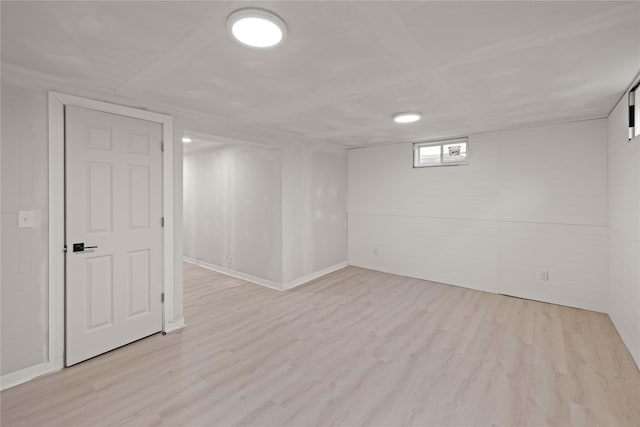 below grade area with light wood-type flooring