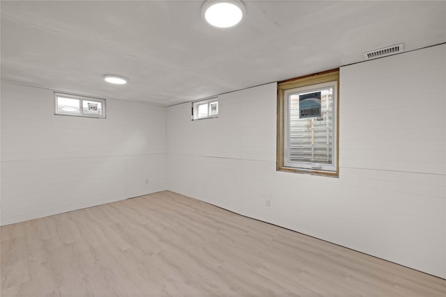 below grade area featuring visible vents and wood finished floors