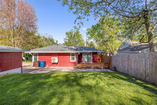 back of property featuring a patio area, roof with shingles, fence, and a lawn