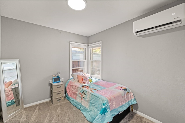 bedroom featuring a wall mounted air conditioner, carpet, and baseboards