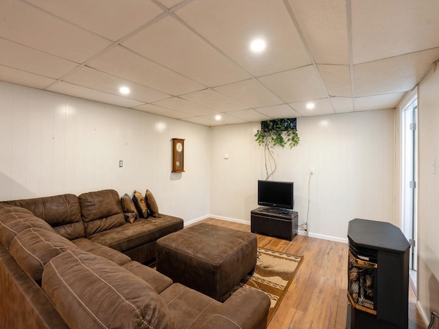 living room with a paneled ceiling, recessed lighting, baseboards, and wood finished floors