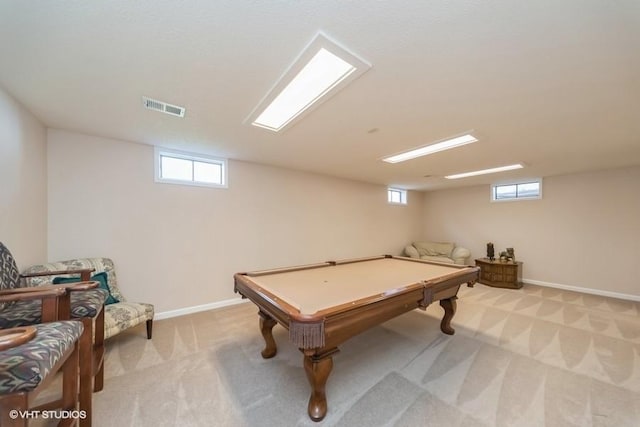 rec room with a healthy amount of sunlight, light carpet, baseboards, and visible vents