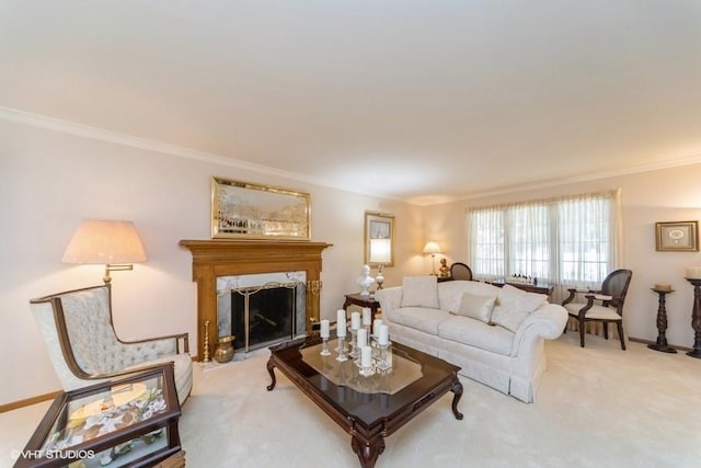 living area with light colored carpet, baseboards, ornamental molding, and a high end fireplace