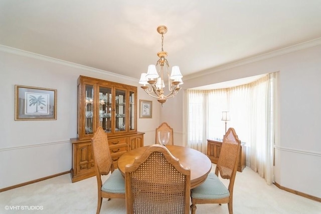 dining room with baseboards, a chandelier, crown molding, and light colored carpet