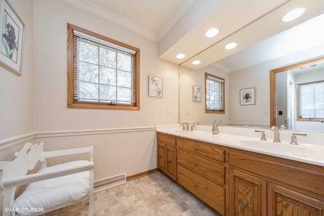 full bath featuring ornamental molding, visible vents, double vanity, and a sink