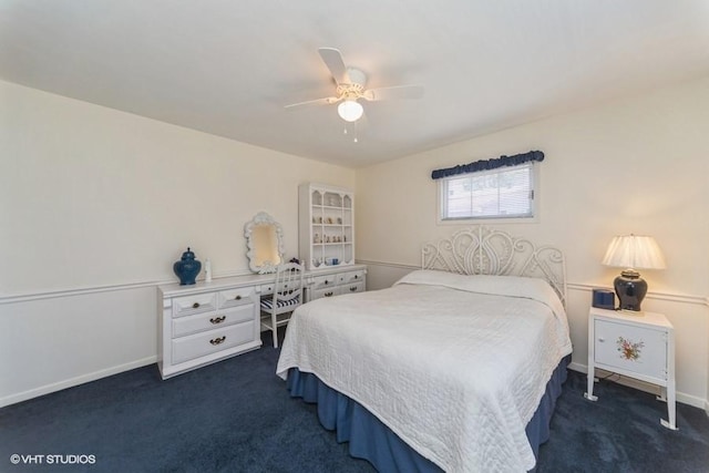 bedroom featuring dark colored carpet, baseboards, and a ceiling fan
