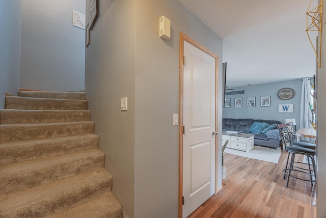 staircase with wood finished floors
