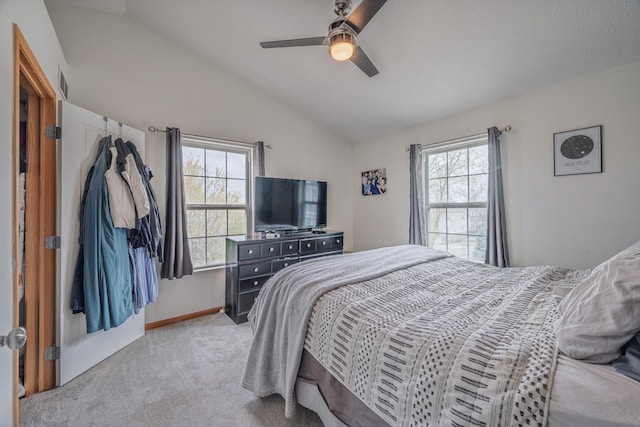 bedroom with light colored carpet, lofted ceiling, visible vents, and multiple windows