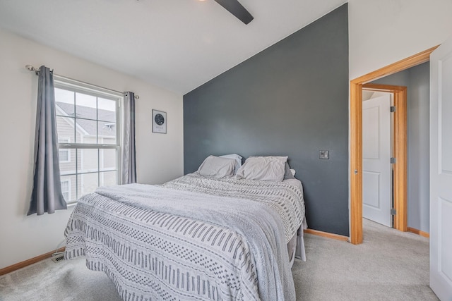 carpeted bedroom featuring baseboards, ceiling fan, and vaulted ceiling