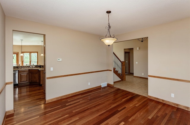 3803 SW 2nd Ct, Ankeny, IA 50023 - empty room featuring wood finished floors, stairs, and baseboards
