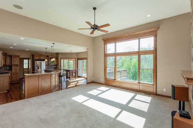 3803 SW 2nd Ct, Ankeny, IA 50023 - unfurnished living room with dark colored carpet, baseboards, and recessed lighting