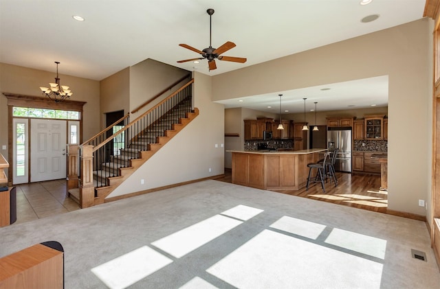 3803 SW 2nd Ct, Ankeny, IA 50023 - kitchen with stainless steel appliances, light carpet, brown cabinets, a chandelier, and recessed lighting