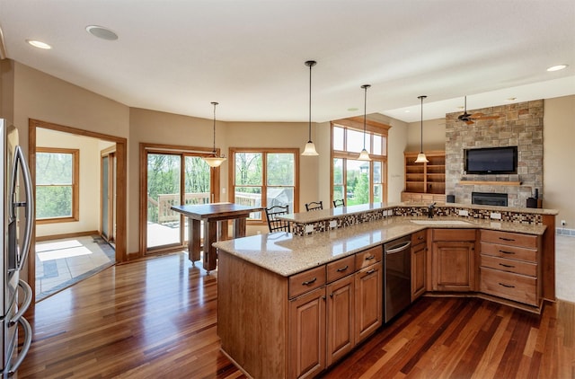 3803 SW 2nd Ct, Ankeny, IA 50023 - kitchen with dark wood-style flooring, appliances with stainless steel finishes, a sink, light stone countertops, and recessed lighting