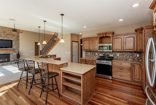 3803 SW 2nd Ct, Ankeny, IA 50023 - kitchen with appliances with stainless steel finishes, dark wood-style floors, open shelves, open floor plan, and recessed lighting