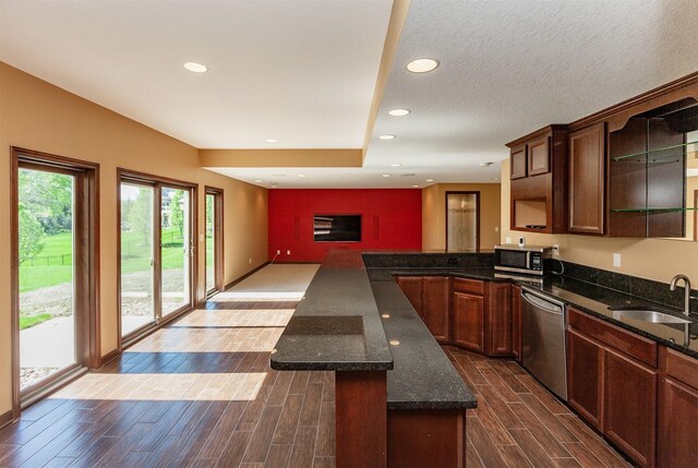 3803 SW 2nd Ct, Ankeny, IA 50023 - kitchen featuring appliances with stainless steel finishes, a sink, a peninsula, dark wood finished floors, and recessed lighting