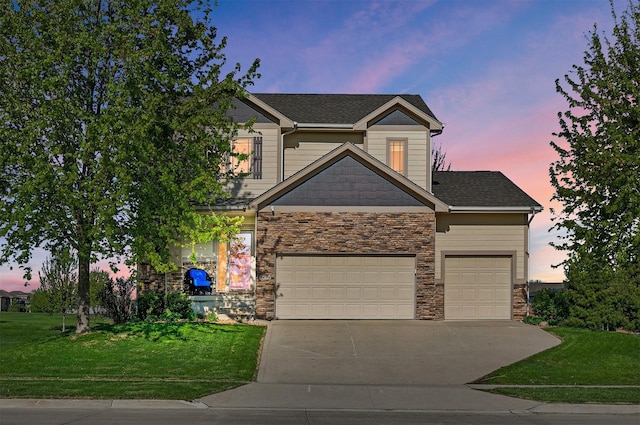 3414 163rd St, Urbandale, IA 50323 - view of front facade featuring stone siding, concrete driveway, a yard, and a garage