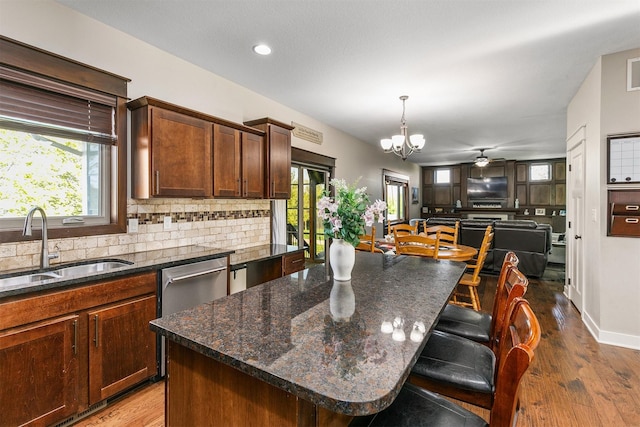 3414 163rd St, Urbandale, IA 50323 - kitchen featuring a sink, tasteful backsplash, a chandelier, wood finished floors, and recessed lighting