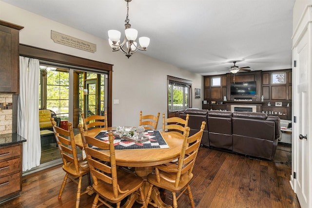 3414 163rd St, Urbandale, IA 50323 - dining space featuring dark wood finished floors, a ceiling fan, a chandelier, and a fireplace