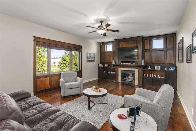 3414 163rd St, Urbandale, IA 50323 - living area featuring a ceiling fan, baseboards, a fireplace, and dark wood finished floors