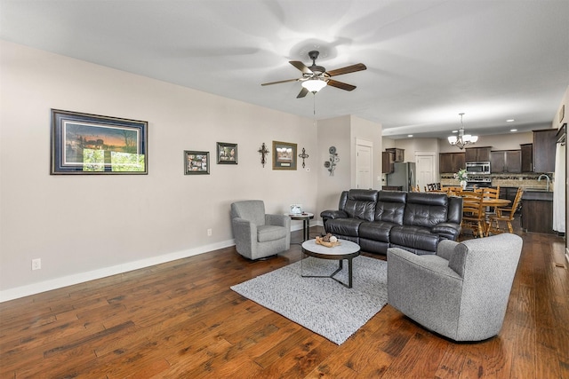3414 163rd St, Urbandale, IA 50323 - living area featuring a chandelier, ceiling fan, baseboards, dark wood-type flooring, and recessed lighting