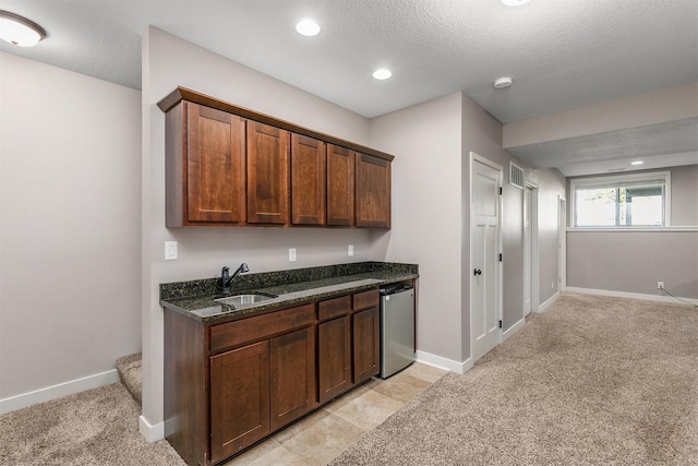 3414 163rd St, Urbandale, IA 50323 - kitchen with a sink, dishwasher, dark stone countertops, light carpet, and baseboards