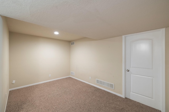 unfurnished room with carpet, baseboards, recessed lighting, and a textured ceiling