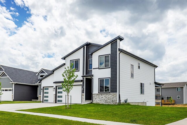 730 NE Country Meadow Dr, Ankeny, IA 50021 - modern home with concrete driveway, stone siding, and a front yard