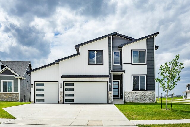 730 NE Country Meadow Dr, Ankeny, IA 50021 - modern home with stone siding, concrete driveway, a front yard, and a garage