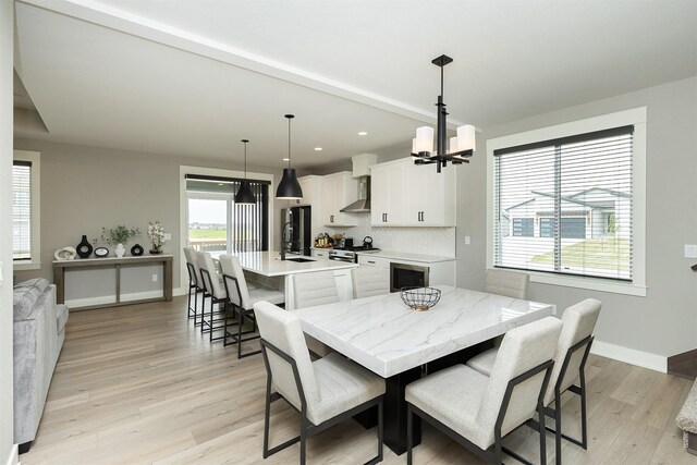 730 NE Country Meadow Dr, Ankeny, IA 50021 - dining area featuring a chandelier, light wood-type flooring, baseboards, and recessed lighting