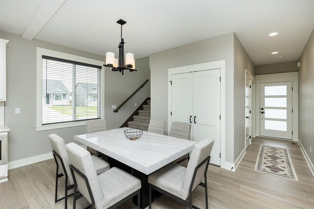 730 NE Country Meadow Dr, Ankeny, IA 50021 - dining room featuring light wood finished floors, a chandelier, baseboards, recessed lighting, and stairway