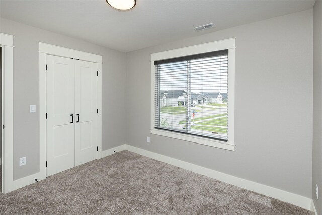 730 NE Country Meadow Dr, Ankeny, IA 50021 - unfurnished bedroom with carpet floors, a closet, and baseboards