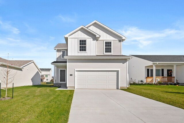 view of front of home with board and batten siding, concrete driveway, a garage, and a front lawn