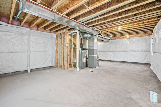 unfinished below grade area featuring water heater and heating unit