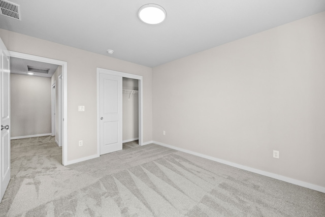 unfurnished bedroom featuring carpet, baseboards, and a closet