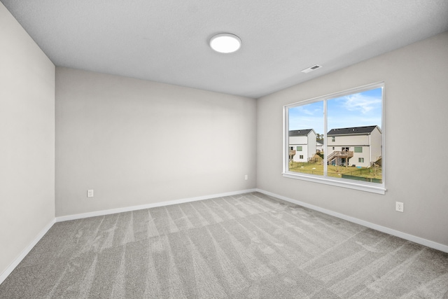 carpeted spare room with baseboards