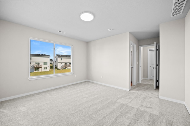 carpeted spare room with baseboards