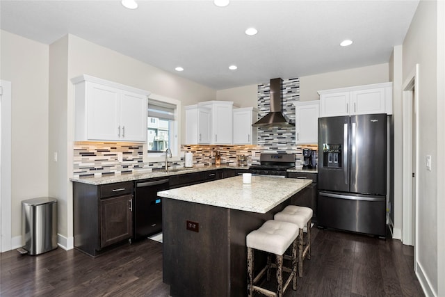 465 NW Gracewood Dr, Waukee, IA 50263 - kitchen with stainless steel appliances, wall chimney range hood, dark wood-style floors, a kitchen island, and recessed lighting