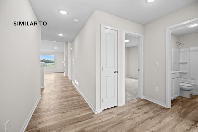 4404 Honey Bee Rdg, Des Moines, IA 50317 - hallway with light wood-type flooring, baseboards, and recessed lighting