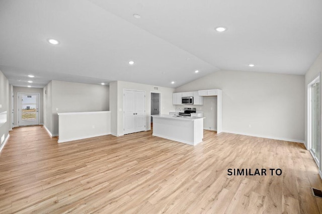 4404 Honey Bee Rdg, Des Moines, IA 50317 - unfurnished living room featuring light wood finished floors, vaulted ceiling, recessed lighting, baseboards, and a sink