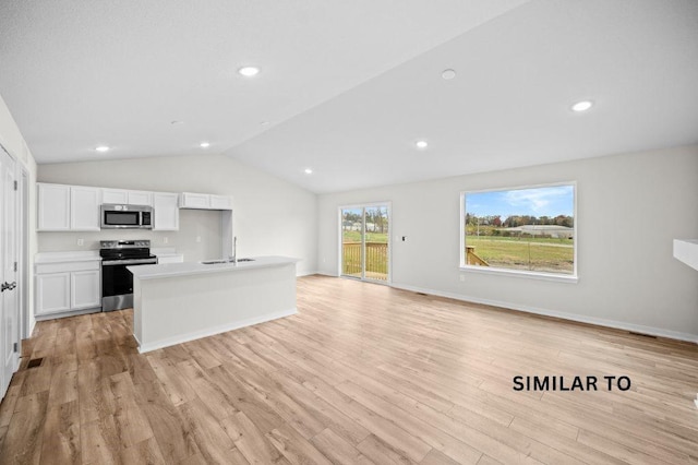 4404 Honey Bee Rdg, Des Moines, IA 50317 - kitchen featuring appliances with stainless steel finishes, a sink, white cabinetry, vaulted ceiling, and light wood-type flooring