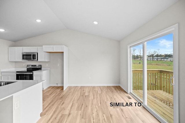 4404 Honey Bee Rdg, Des Moines, IA 50317 - kitchen with stainless steel appliances, white cabinetry, lofted ceiling, light wood finished floors, and light countertops