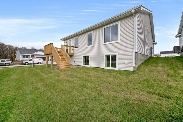 4408 Honey Bee Rdg, Des Moines, IA 50317 - back of house featuring stairs, a yard, and a deck