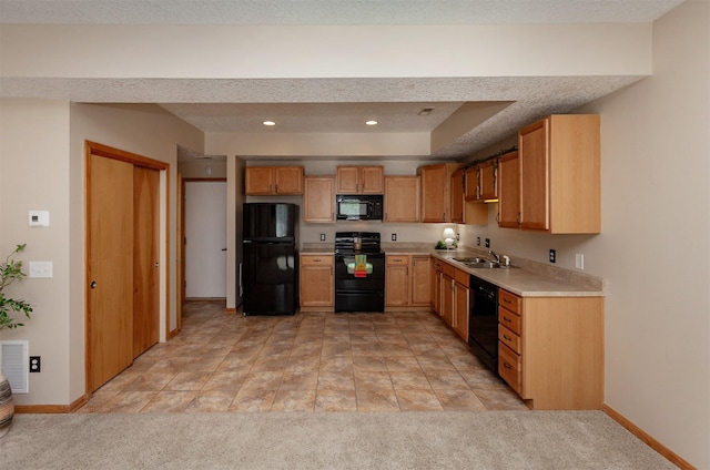 kitchen featuring black appliances, a sink, light countertops, baseboards, and recessed lighting