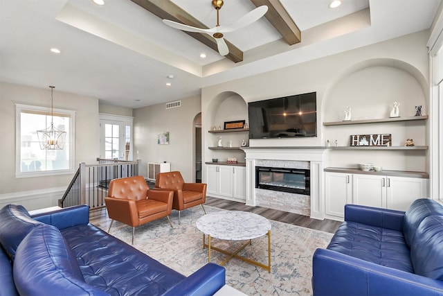 3316 NW 27th St, Ankeny, IA 50023 - living area with wood finished floors, a ceiling fan, recessed lighting, arched walkways, and a glass covered fireplace
