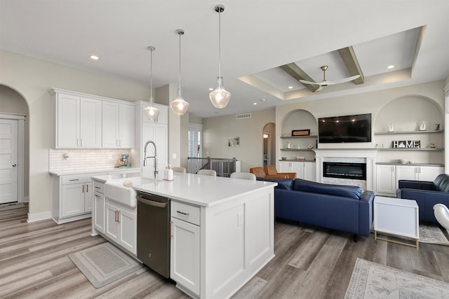 3316 NW 27th St, Ankeny, IA 50023 - kitchen with dishwasher, arched walkways, a sink, light wood-style flooring, and ceiling fan